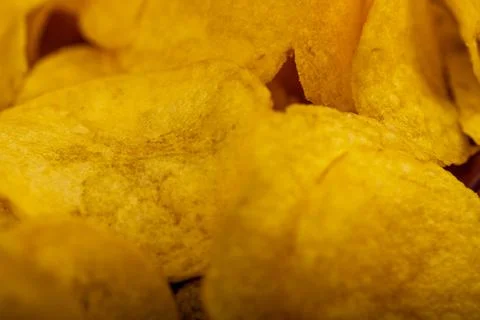 Potato chips scattered on the table, close-up, selective focus. Stock Photos