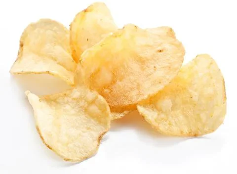 Potato chips scattered on white surface for snack Stock Photos