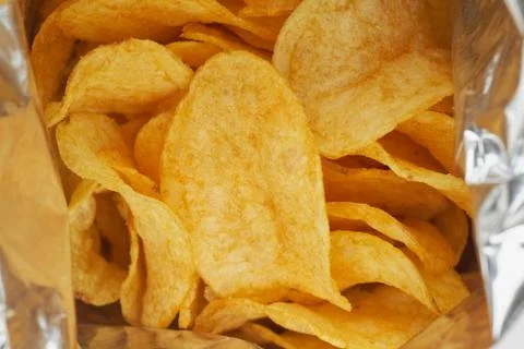 Potato chips in a silver package. Close-up. Stock Photos