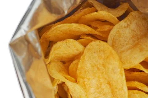 Potato chips in a silver package isolated on a white background close-up. Stock Photos