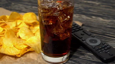 Potato chips with soda and remote control Stock Footage 68908559