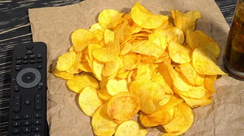 Potato chips with soda and remote control Stock Footage 69027649