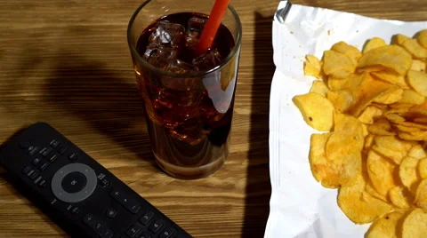 Potato chips with soda and remote control Видео 69029298