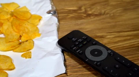 Potato chips with soda and remote control Stock Footage 69029685