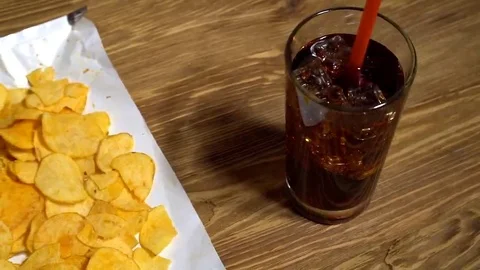 Potato chips with soda and remote control Stock Footage
