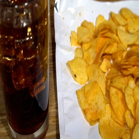 Potato chips with soda and remote control Video stock 69341901