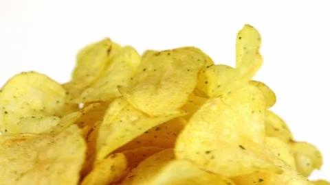 Potato chips spin in a circle on a light background Video stock 229503617