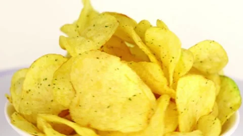 Potato chips spin in a circle on a light background Stock-Footage 229724930