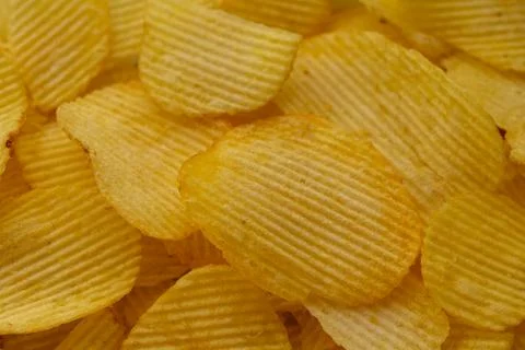 Potato chips spread in a plate close-up Stock Photos