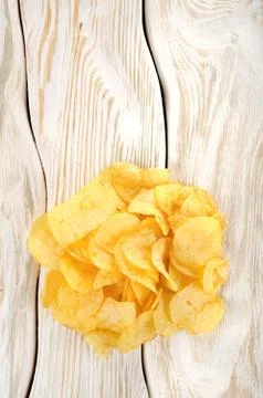 Potato chips on a white table Stock Photos