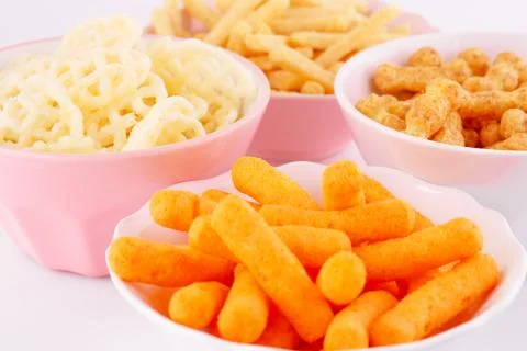 Potato, corn and wheat chips in bowls Stock Photos
