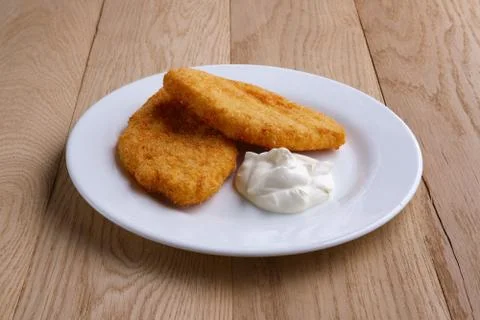 Potato cutlet in breading stuffed with ham served with sour cream on wooden t Stock-Fotos
