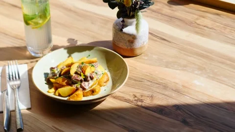 A potato dish with a refreshing drink and a beautiful plant for a delicious Stock Footage 311871895