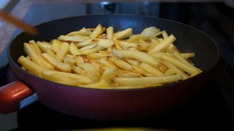 The potato is fried in a frying pan Stock Footage 77680556