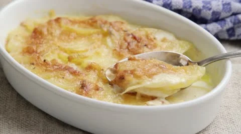 Potato gratin in a baking dish with a spoon Stock Footage 24657717