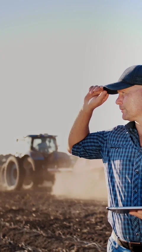 Potato harvesting. farmer using digital tablet. on farm field, on farm machinery Stock Footage 314115827