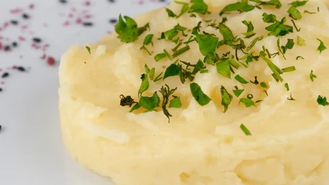 Potato mashed with parsley on top, close-up view, served in Restaurant Stock Footage 95675135