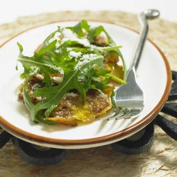 Potato omelet with rucola and parmasan Stock Photos