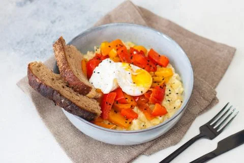 Potato risotto with grilled red pepper, poached egg and warm bread Stock Photos