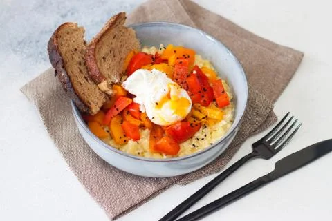 Potato risotto with grilled red pepper, poached egg and warm bread Stock Photos
