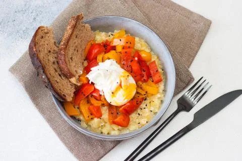 Potato risotto with grilled red pepper, poached egg and warm bread Stock Photos
