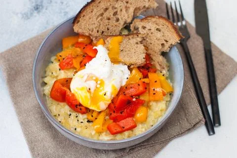 Potato risotto with grilled red pepper, poached egg and warm bread Stock Photos