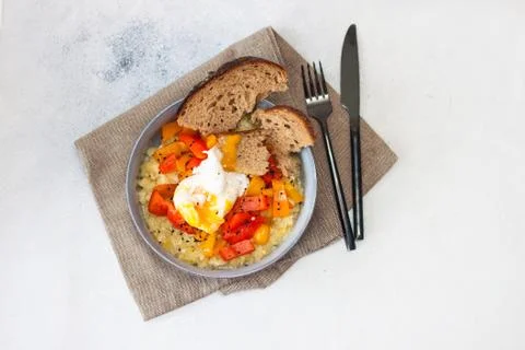Potato risotto with grilled red pepper, poached egg and warm bread Stock Photos