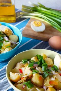Potato salad in green and blue bowls Stock Photos