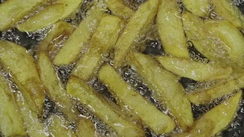 Potato slices are fried in boiling oil. Top view. Stock Footage 221130484