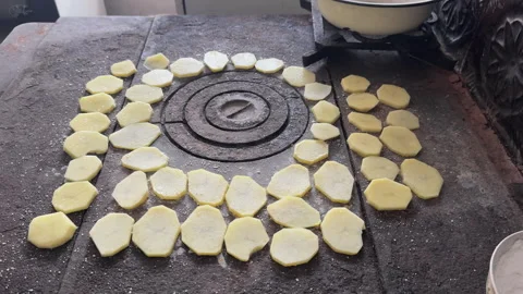 Potato slices drying on an old stove Stock Footage 340237813