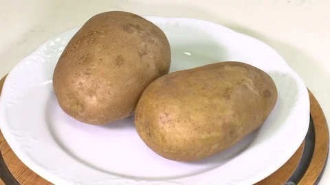 Potato spinning on a plate Stock Footage 119650723