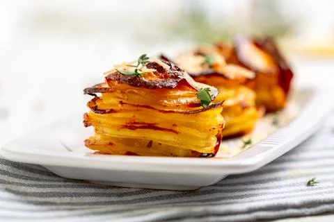 Potato stacks with parmesan. Stock Photos