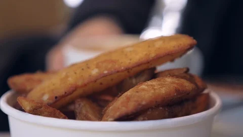 Potato wedges in cafe waitress delivers coffee shallow focus slow motion Stock Footage 111741853
