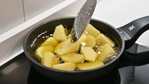 Potatoes to add to a stew. Adding to the pan Stock Footage 217983964