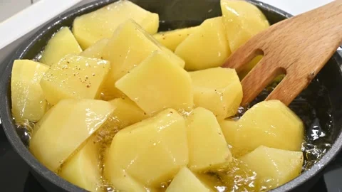 Potatoes to add to a stew. Moving to make them tasty Stock Footage 217983957