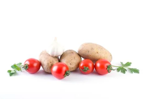 Potatoes and tomatoes on a white background. Potatoes on a white background. Stock Photos