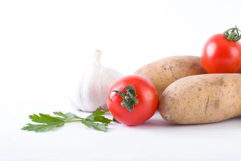 Potatoes and tomatoes on a white background. Potatoes on a white background. Stock Photos
