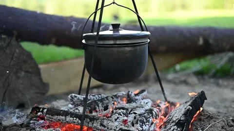 Potatoes are boiling in a pot over the fire. Cooking in the campaign Stock Footage 133554774