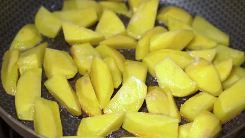 Potatoes are fried in a pan, close-up Stock Footage 248069141