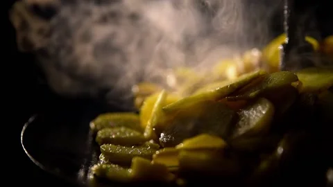 The potatoes are fried in a pan over an open fire Stock Footage 158767595