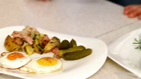 Potatoes with bacon and fried eggs and a sprig of dill Stock Footage 10764200
