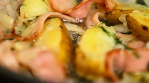 Potatoes with bacon and fried in a pan Stock Footage 10764455