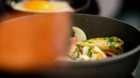 Potatoes with bacon and fried in a pan. eggs Stock Footage