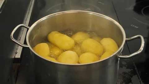Potatoes beginning to boil in a Saucepan Video stock 240568013