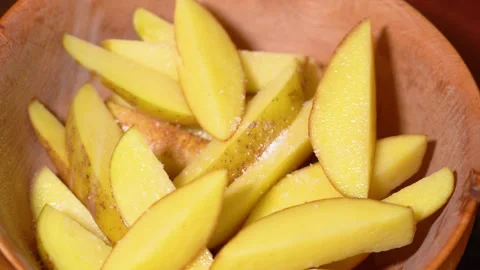 Potatoes being prepared for baking in the oven Stock Footage 250441254