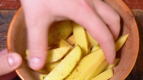 Potatoes being prepared for baking in the oven Stock Footage 250441333