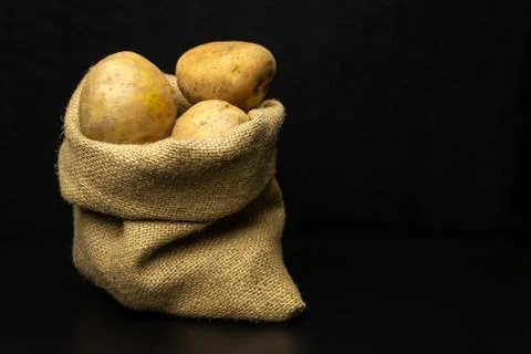 Potatoes on a black background Stock-Fotos