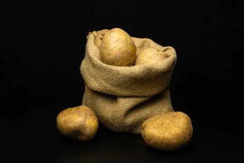 Potatoes on a black background Stock Photos