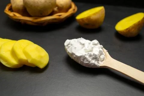 Potatoes on a black background Stock Photos