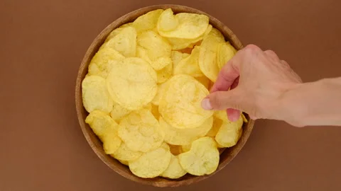 Potatoes chips. Hands of different people that take chips from bowl Stock Footage 197620918